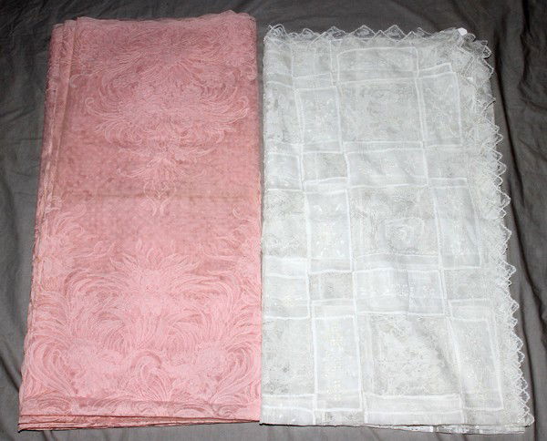 TABLECLOTHS, TWO, L 80", 144": TABLECLOTHS, TWO, L 80", 144":One is white linen measuring 80" x 70", the second is pink lace (machine), measuring 144" x 72".