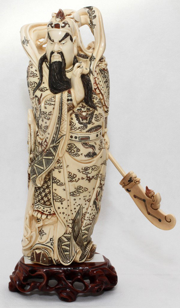 CHINESE CARVED IVORY FIGURE OF GUAN YU,: CHINESE CARVED IVORY FIGURE OF GUAN YU, H 9 1/2", L 3":The figure is shown wearing elaborate garments and holding a Guan Dao (polearm). Signed at the underside. Includes a wood stand and a fitted box.