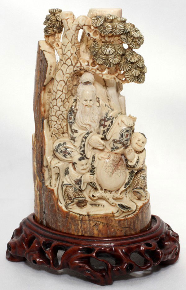 CHINESE IVORY CARVING, H 6 1/2",: CHINESE IVORY CARVING, H 6 1/2", L 3 1/2":Carving depicts a deity and 2 other figures. Signed. Includes a wood stand and a fitted box.