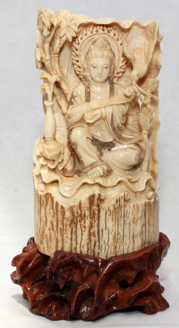 CHINESE CARVED IVORY FIGURE OF QUAN YIN,: CHINESE CARVED IVORY FIGURE OF QUAN YIN, H 5 3/4", L 3":Figure of Quan Yin is shown seated in lotus position, with a halo around her head and a ruyi scepter in her right hand. No apparent markings. In