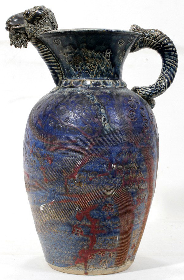 MICHAEL KENNEDY, IRISH ART POTTERY JUG,: MICHAEL KENNEDY (20TH C.), IRISH ART POTTERY JUG, 1989, H 14 3/4":A ceramic jug with snake-form handle and ram's head at the spout; stamped at the side of the base, signed and dated underneath (see ad