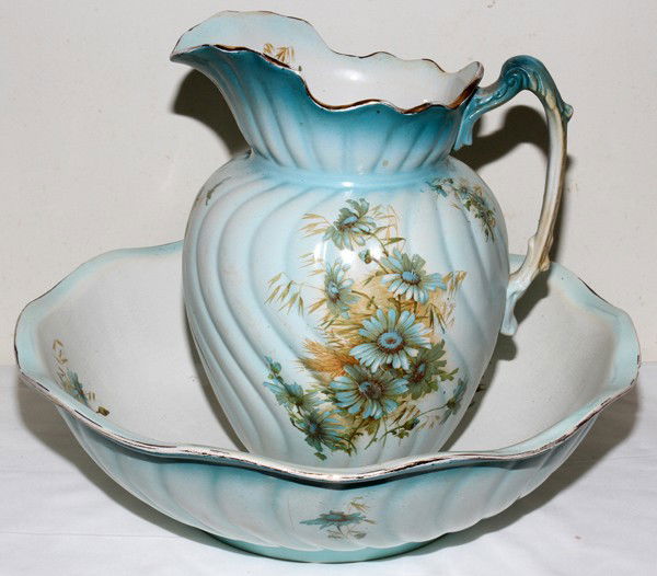 DEMI PORCELAIN WATER PITCHER & BASIN,: DEMI PORCELAIN WATER PITCHER & BASIN, C. 1910:Blue and white with floral decoration. Including 1 water pitcher, H. 11", stamped logo at the underside enclosing "M & C/L" and 1 basin, H. 4 1/2", Dia. 1