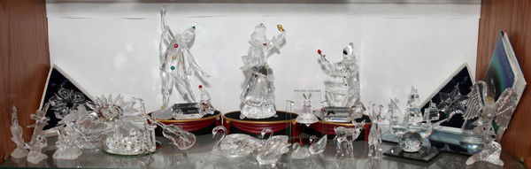 SWAROVSKI CRYSTAL GROUPING: SWAROVSKI CRYSTAL GROUPING:Includes a harlequin, swan, eagle, birds, rabbits, ships, violin and a saxophone etc. From the estate of Audrey Stanko, Sterling Heights, Mi.