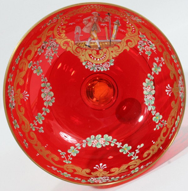 MURANO VENICE BLOWN GLASS & ENAMEL BOWL,: MURANO VENICE BLOWN GLASS & ENAMEL BOWL, C. 1920, H 3", DIA 5":H 3 1/4". Enamel courtier and floral swags. H 3 1/4". Circa 1920. ruby glass with clear pedestal base.