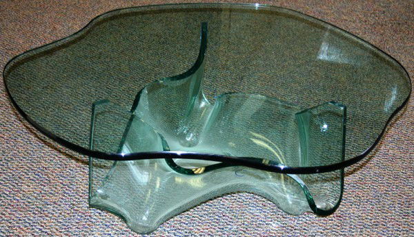 LAUREL FYFE, GLASS COCKTAIL TABLE, "AURORA",: LAUREL FYFE, (AMER. 1956-2011), CONTEMPORARY, GLASS COCKTAIL TABLE, "AURORA", H 17", DIA 44":"Aurora" cocktail table having a contoured free form design top with a free form glass base;