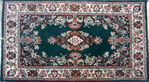 INDIA, HAND WOVEN WOOL RUG, 2' X 3': INDIA, HAND WOVEN WOOL RUG, 2' X 3':having a green ground, three borders, center floral medallion, flower filled vases at the sides and floral designs throughout.