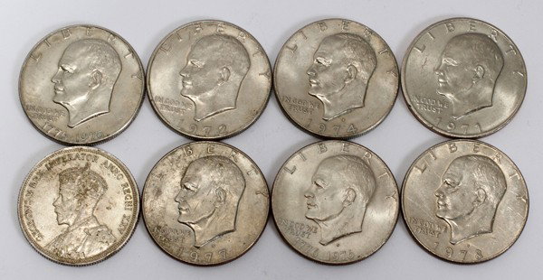 EISENHOWER U.S. MINT $1 COINS +CANADIAN SILVER: EISENHOWER U.S. MINT $1.00 COINS +CANADIAN SILVER DOLLAR:includes one 1935 Canadian Voyageur "Silver Jubilee" silver dollar. "HB" stamped on a bundle of fur in canoe. Stamped "EH" under stern of canoe