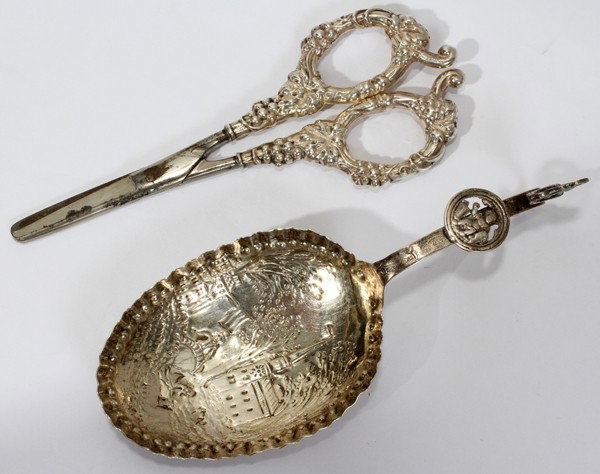DUTCH STERLING SCISSORS & SERVING SPOON, C 1888: DUTCH STERLING SCISSORS & SERVING SPOON, C 1888, 2 PCS., L 7" - 8":sheers having a fruit and leaf design, stainless blades, spoon with castle design, gold wash, 1.48 tr. oz. Lion with key mark and Eng