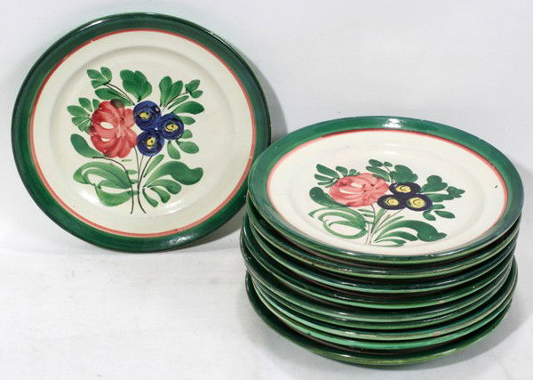 ITALIAN POTTERY PLATES, 9 PCS.: ITALIAN POTTERY PLATES, 9 PCS.:nine Italian pottery plates, green and red stripe rims, off white ground, with flower designs in the centers.
