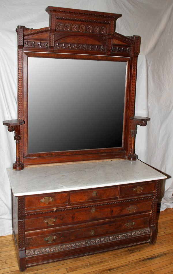 EASTLAKE WALNUT BEDROOM SUITE, THREE PIECE: EASTLAKE WALNUT BEDROOM SUITE, THREE PIECE:Each piece is nicely carved with period hardware and includes a headboard H 81", L 63" accompanied by a footboard, a mirrored marble top dresser H 85", L 54,