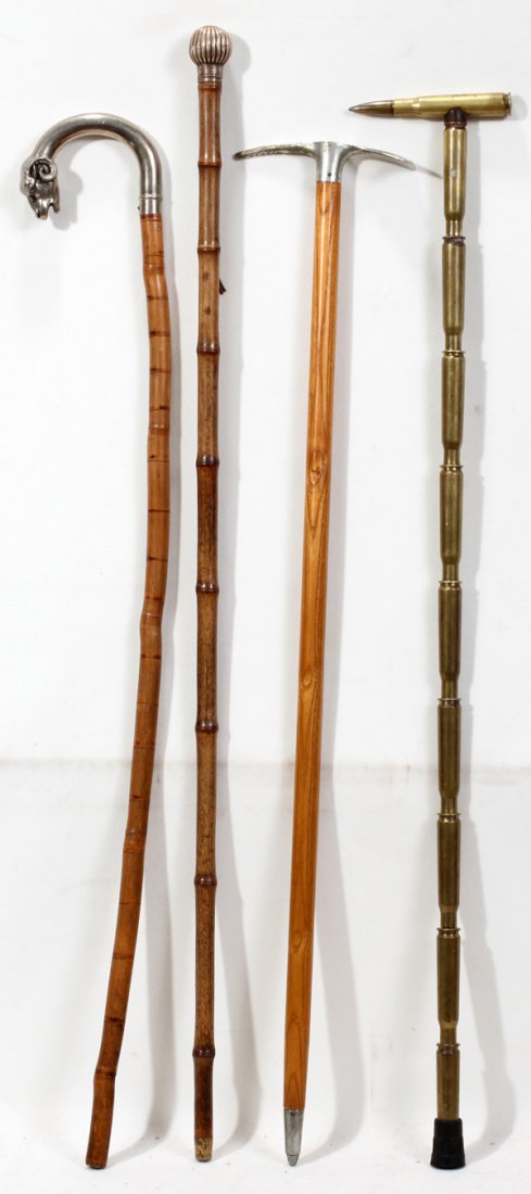 WALKING STICKS & WWII CARTRIDGE HANDGRIPS FOUR: WALKING STICKS, INCLUDING SILVER & WWII CARTRIDGE HANDGRIPS, FOUR, L 28" - 32":includes one silver ram's head and bamboo, one Swiss climbing cane, one English silver and bamboo and one U.S. WWII .50 c
