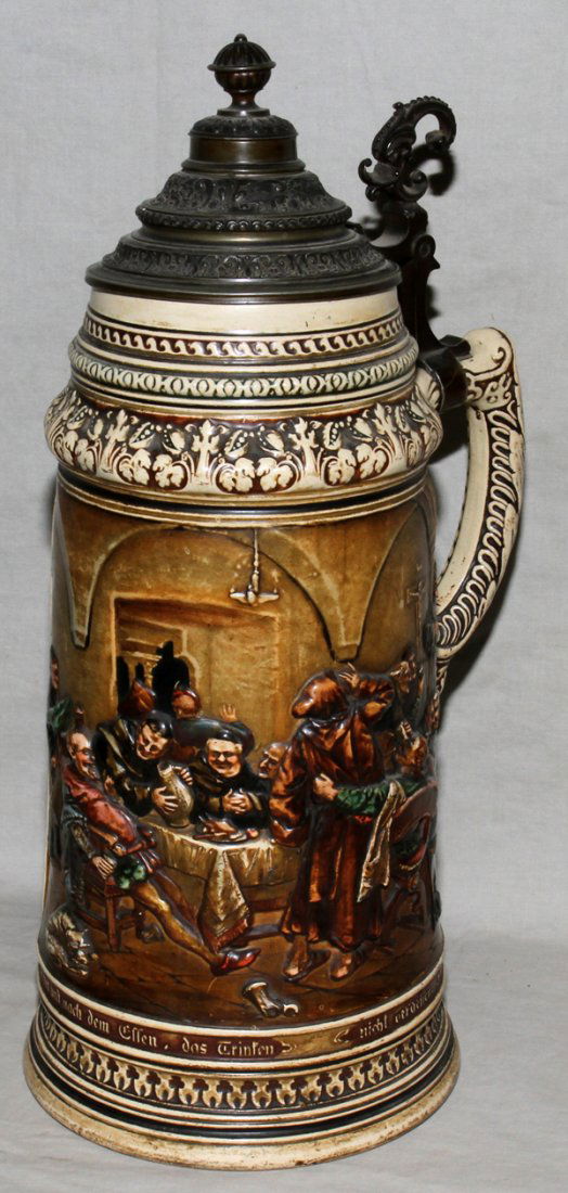 GERMAN BEER STEIN, MAGNUM 16": GERMAN BEER STEIN, MAGNUM, H 16", DIA 6":Beer garden scene in relief. With metal hinged lid.