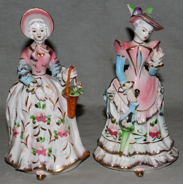 ORIGINAL ARNART CREATION, JAPAN, FIGURINES: 'ORIGINAL ARNART CREATION, JAPAN', PORCELAIN FIGURINES, TWO, H 7":Women in period dresses with hats. Arnart Japan Cross swords marks on bottom with #7833.