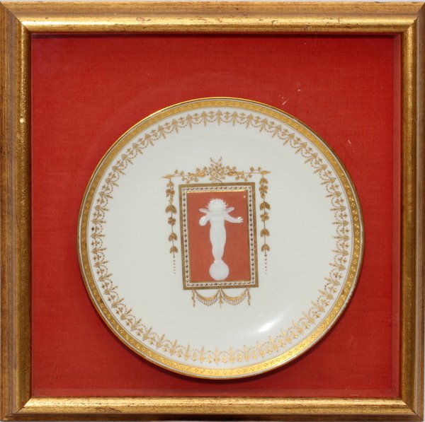 MINTONS PATE-SUR-PATE PORCELAIN CABINET PLATE: MINTONS PATE-SUR-PATE PORCELAIN CABINET PLATE, DIA 9 1/2", FRAMED:A white porcelain plate centered by a rectangular reserve enclosing a white slip decorated figure of Cupid atop a globe symbolizing lo