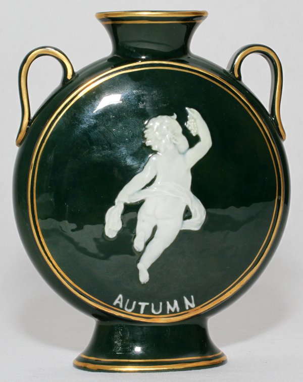 PATE-SUR-PATE PORCELAIN FLASK VASE,: PATE-SUR-PATE PORCELAIN FLASK VASE, 'AUTUMN', EARLY 20TH C., H 6", W 4 3/4":Decorated with a putto allegory of Autumn in white slip on a dark green ground with gilt accents; no apparent marks.