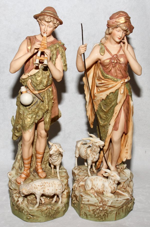 ROYAL DUX PORCELAIN FIGURES EARLY 20TH C.: ROYAL DUX PORCELAIN FIGURES, EARLY 20TH C., PAIR, H 15":A shepherd with pipe and shepherdess with staff, lambs and goats at their feet, numbered 135 and 136 respectively, raised triangular mark indica