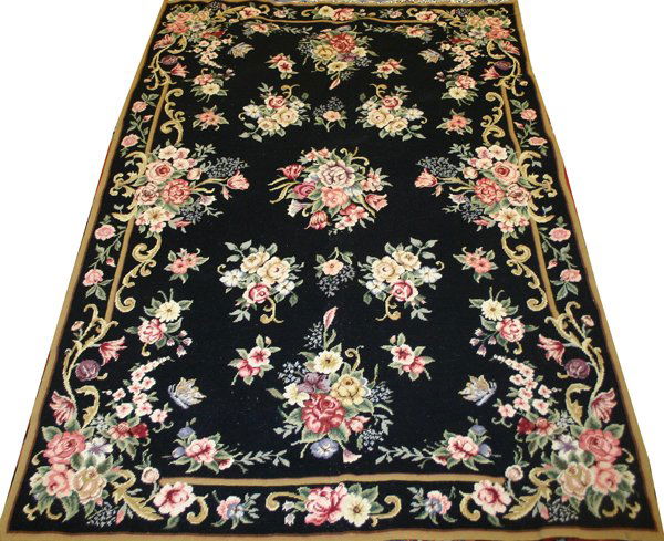 NEEDLEPOINT RUG, 6' 0" X 4' 0": NEEDLEPOINT RUG, 6' 0" X 4' 0":Black ground adorned with floral sprays and scrolls.