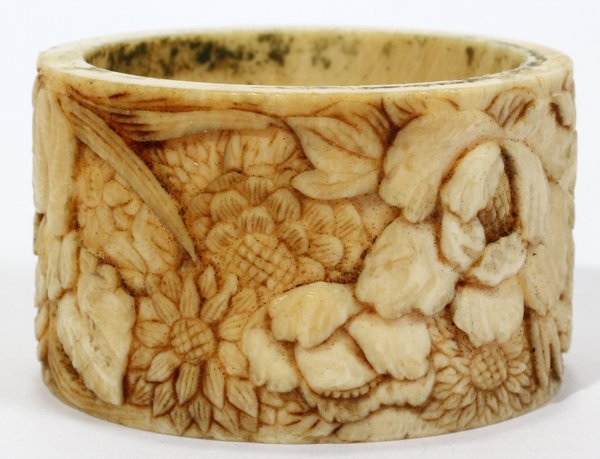 CHINESE CARVED IVORY NAPKIN RING: CHINESE CARVED IVORY NAPKIN RING, DIA 1 3/4":Carved in low relief with a continuous band of flowers.IVORY CANNOT BE SHIPPED OUTSIDE OF THE CONTINENTAL UNITED STATES.