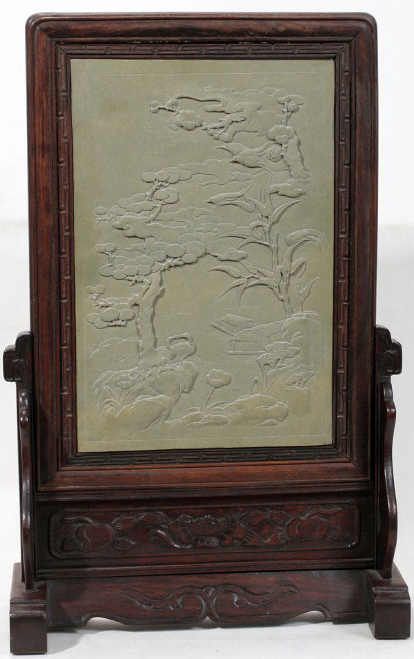 CHINESE CARVED STONE PANEL 19TH C., 13" X: CHINESE CARVED STONE PANEL, 19TH C., 13" X 8 1/2":Raised relief landscape scene with trees and buildings; set into a carved wood wall frame/table stand with fret and fruit motif; unsigned. 20" x 11" o
