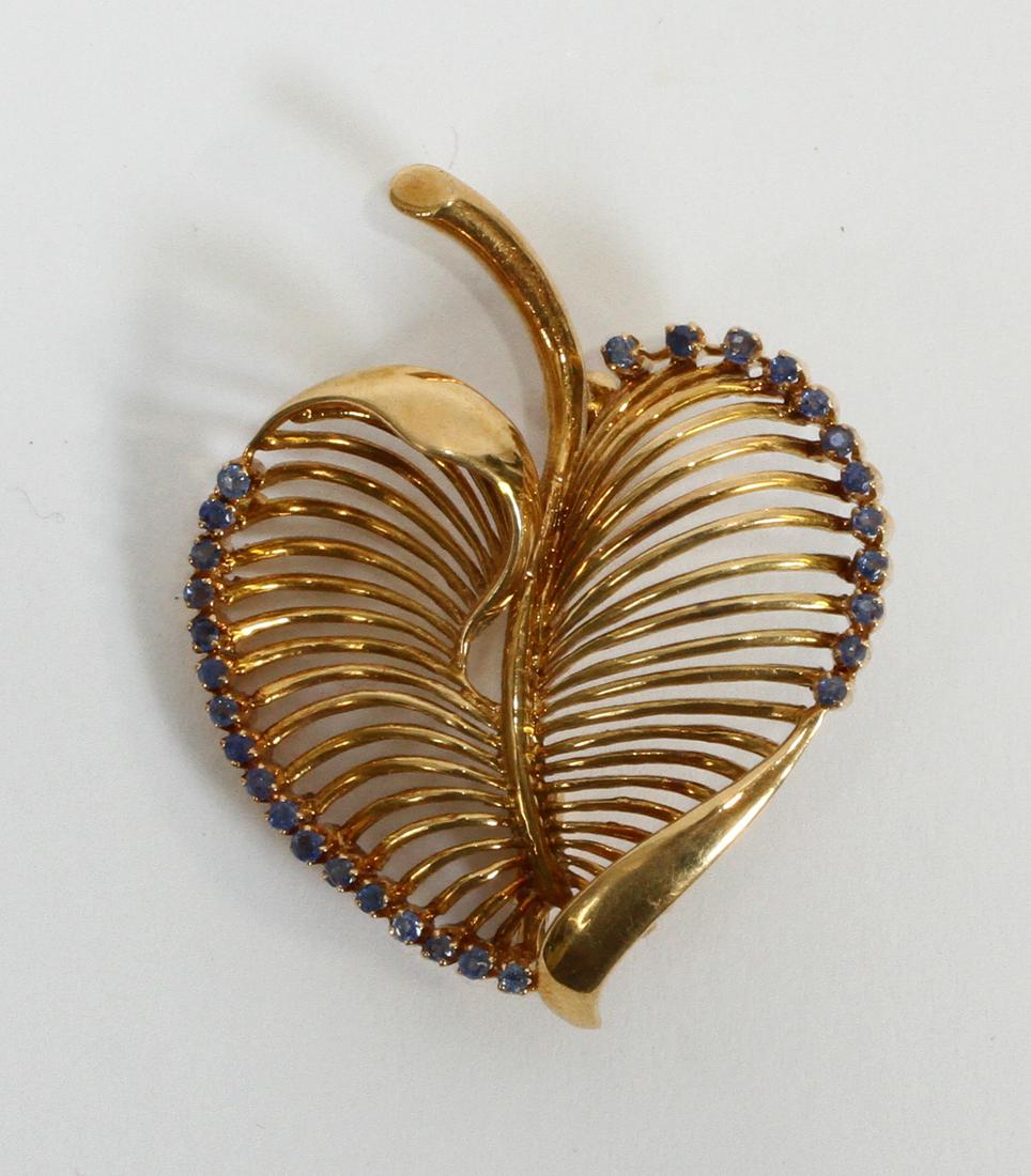 18K Yellow Gold And Blue Sapphire Leaf Form Brooch, Italy H 1.7'' 9.6g: 18K Yellow Gold And Blue Sapphire Leaf Form Brooch, Italy H 1.7'' 9.6g | Impressed 18K and Italy. 29 blue sapphires prong set along edge. Provenance: From the Estate of Prominent Collector, Leon Zieli