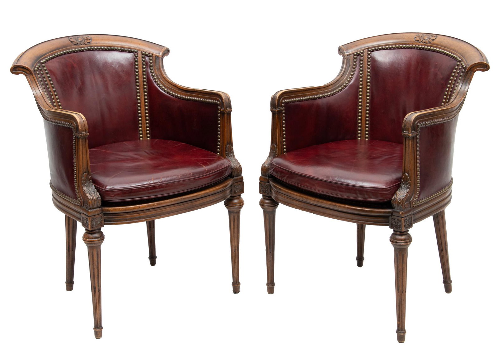 Pair of Burgundy Leather And Carved Walnut Arm Chairs H 34.25" W 21.75" Depth 20.5": Pair of Burgundy Leather And Carved Walnut Arm Chairs H 34.25" W 21.75" Depth 20.5" | On straight tapered legs with brass nailhead trim.