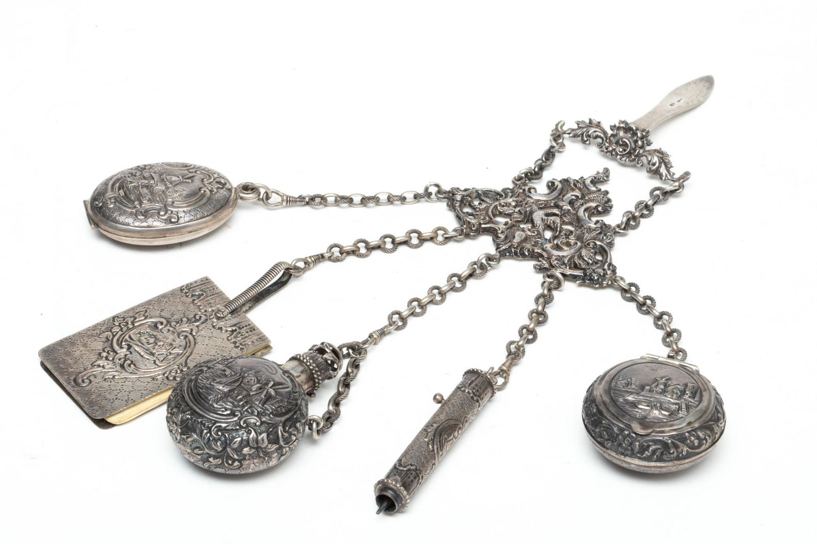 Sterling Silver Chatelaine, L 9": Sterling Silver Chatelaine, L 9" | Hallmarks on hook and integrated into front design. Two tiers with scrolling leaves and central bird. Having 5 chains including: mirror, tablet, perfume bottle, penc