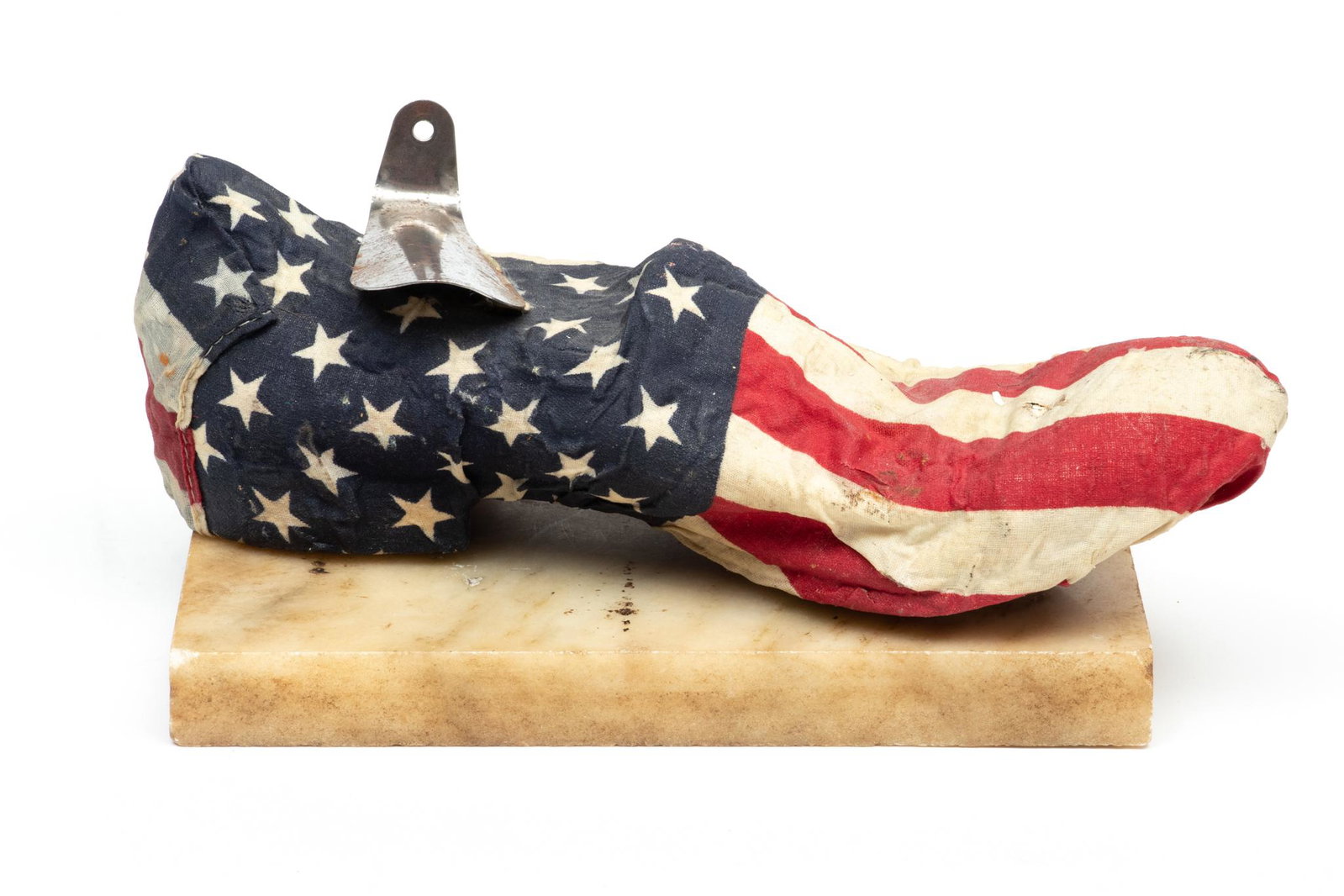 Tyree Guyton (American, B. 1955) American Shoe Sculpture: Tyree Guyton (American, B. 1955) American Shoe Sculpture | with American Flag and shoe horn, along with marble base. Provenance: Property from a Bloomfield Township, MI private collection.