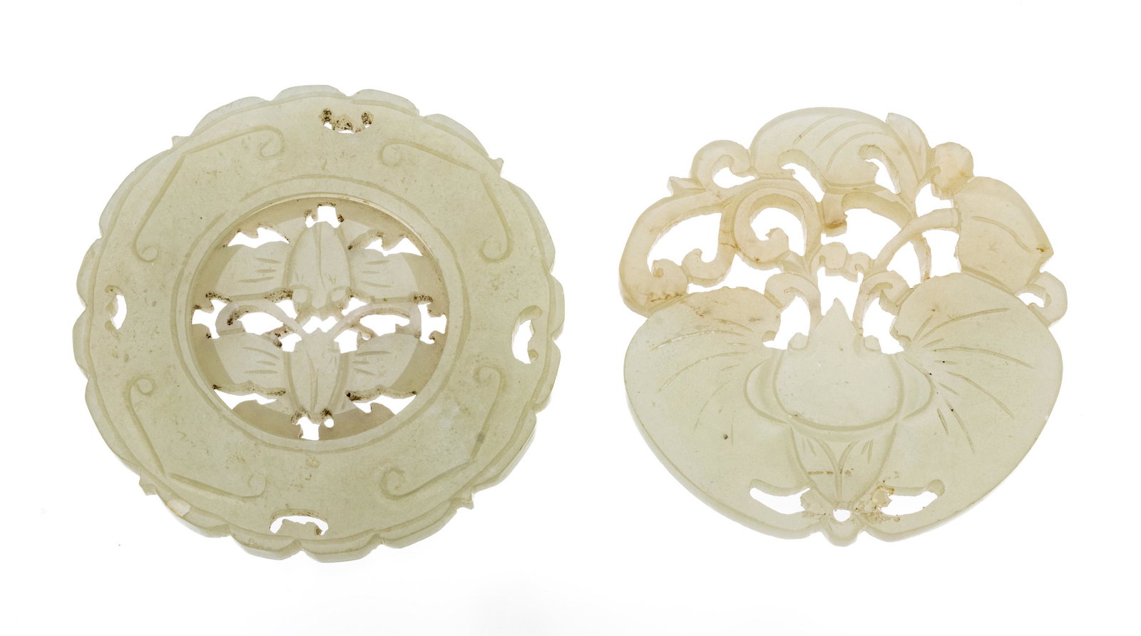 Chinese Carved Jade Discs Ca. 1900, Dia. 2.2" 57g 2 pcs: Chinese Carved Jade Discs Ca. 1900, Dia. 2.2" 57g 2 pcs | Pale green Dia. 2.2" and 2.1". Finely carved abstract motifs with piercing. One with free-turning center. Provenance: From the Estate of Promi