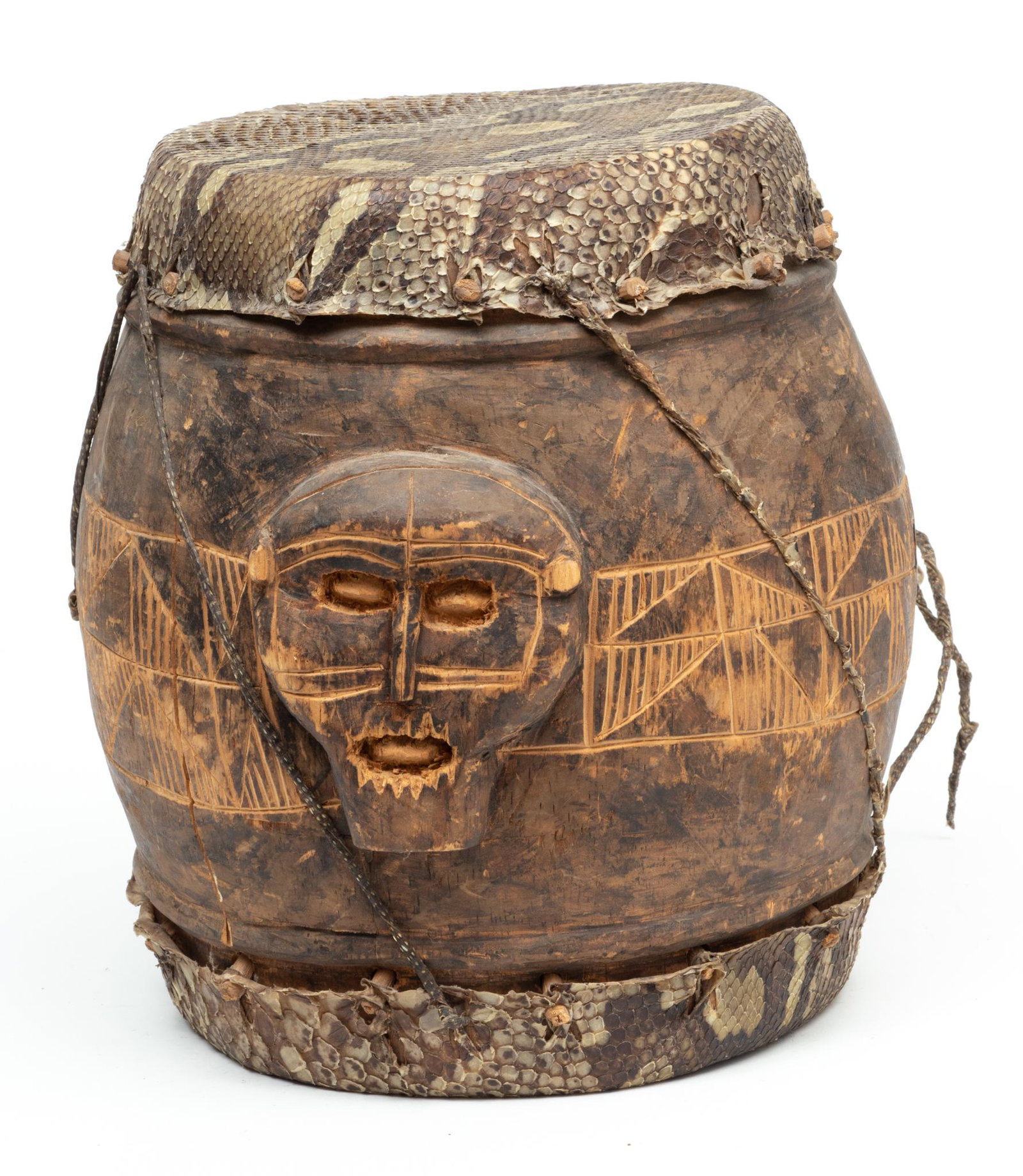 Papua New Guinean Carved Wood And Snake Skin Drum, H 10.75" Dia. 11": Papua New Guinean Carved Wood And Snake Skin Drum, H 10.75" Dia. 11" | With geometric carvings on the sides, snakeskin on two sides. Provenance: Property from a Bloomfield Township, MI private collect