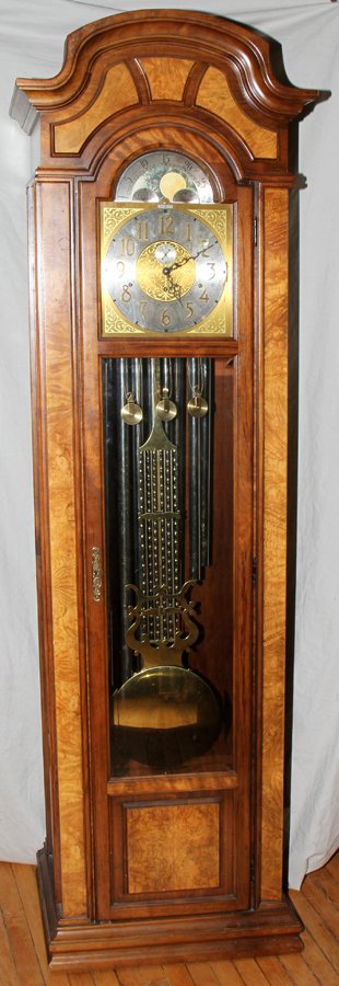 HOWARD MILLER BURL WOOD VENEER TALL CASE CLOCK: HOWARD MILLER, BURL WOOD VENEER, TALL CASE CLOCK, LATE 20TH C, H 87", W 27", D 17":having arched crown molding across the top front and moldings along the sides; a burl wood paneled case, nine chime t