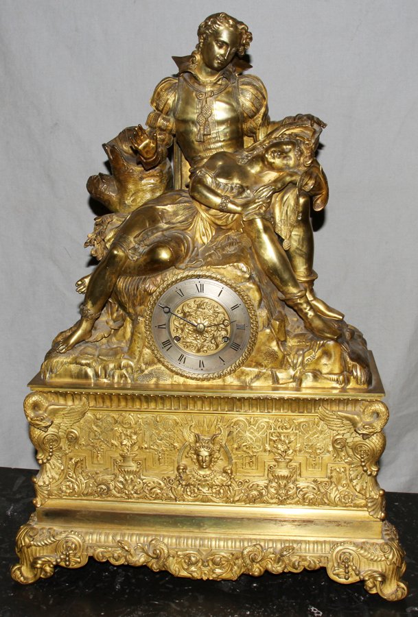 FRENCH FIGURAL GILT BRONZE MANTLE CLOCK, H 27": FRENCH FIGURAL GILT BRONZE MANTLE CLOCK, H 27", W 17", D 7":gilt bronze mantle clock depicting a woman asleep on a mans lap; small brushed steel band on the face with black enamel Roman numerals; gilt