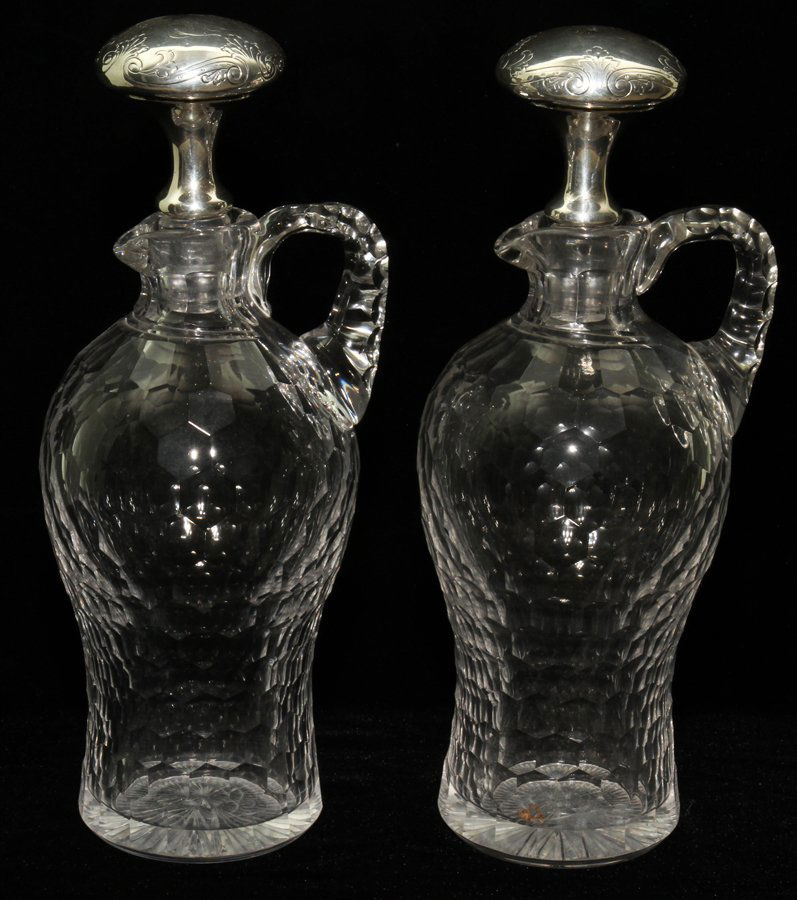 CUT GLASS CRUETS WITH STERLING STOPPERS,: CUT GLASS CRUETS WITH STERLING STOPPERS, PAIR, H 12":Cut honeycomb pattern. The stoppers with engraved "HHP" monogram. From the Estate of Julie Cudlip Whitman, Grosse Pointe Farms.