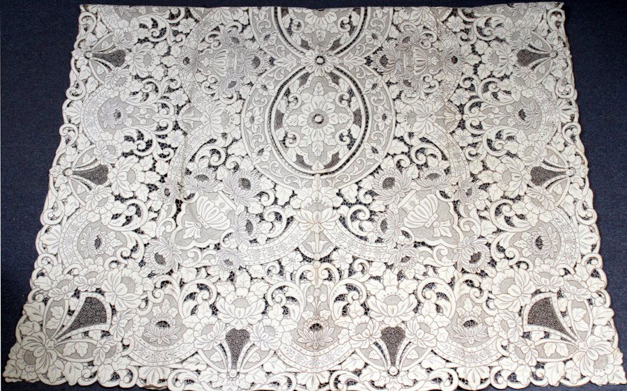 LACE HAND-SEWN BANQUET SIZE TABLE CLOTH: LACE HAND-SEWN BANQUET SIZE TABLE CLOTH, 98" X 66":Ecru in color. Accompanied by twelve linen and lace napkins 19" square, also ecru in color.