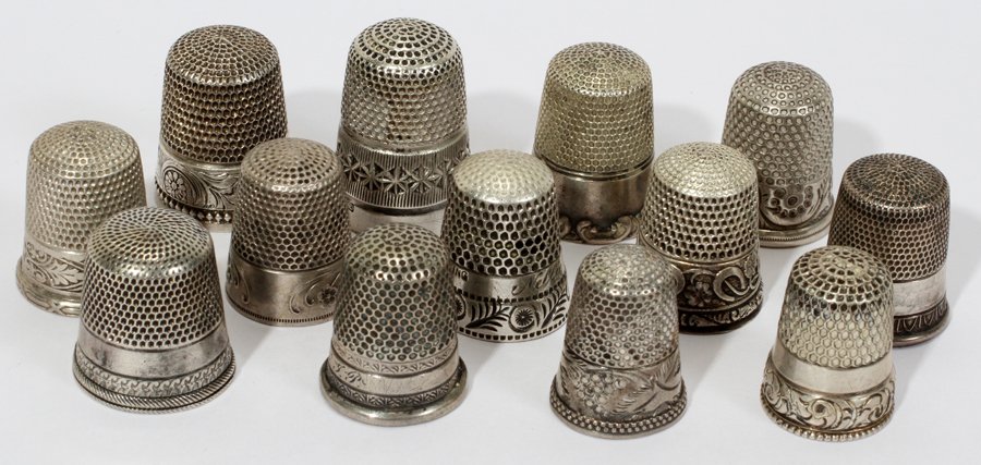 AMERICAN & ENGLISH STERLING & SILVER THIMBLES: AMERICAN & ENGLISH STERLING & SILVER THIMBLES, C. 1900, 13, H 1":Including 8 stamped "Sterling" by such makers as Sterns Bros., Simons Bros., and Waite, Thresher & Co., and 1 English sterling (Chester