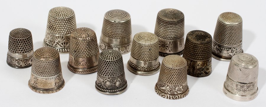 AMER. & CONTINENTAL STERLING & SILVER THIMBLES: AMERICAN & CONTINENTAL STERLING & SILVER THIMBLES, ANTIQUE, TWELVE, H 1":Including 6 thimbles stamped "Sterling", 1 .800 silver thimble, 2 only marked with Simons Bros. logo, and 3 unmarked. The six s