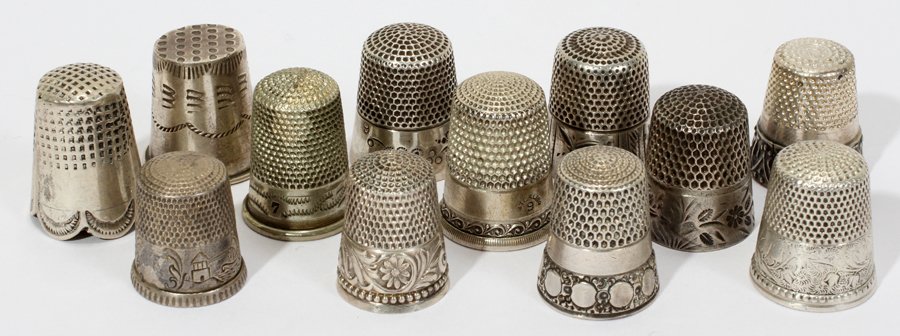 AMER. & CONTINENTAL STERLING & SILVER THIMBLES: AMERICAN & CONTINENTAL STERLING & SILVER THIMBLES, C. 1900, TWELVE, H 1":Including 8 thimbles marked sterling, one of which is marked "Made in Portugal", and includes such makers as Simons Bros., Ketc