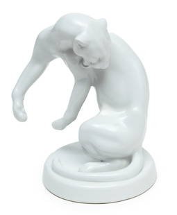 Meissen (German) Blanc De Chine Porcelain Figurine, Preening Jaguar, H 7" W 5": Meissen (German) Blanc De Chine Porcelain Figurine, Preening Jaguar, H 7" W 5" | Depicting a jaguar preening its coat. Bearing blue crossed swords mark under glaze.