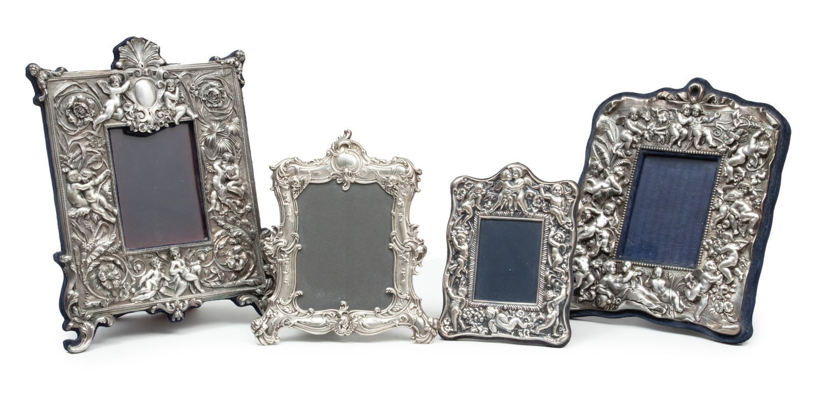 English Sterling Silver Repousse & Silver Plate Photo Frames, H 13" W 10" 4 pcs: English Sterling Silver Repousse & Silver Plate Photo Frames, H 13" W 10" 4 pcs | In descending size, the lot includes one silver plate frame (H 13" x W 10"), one sterling silver repousse frame (H 11"