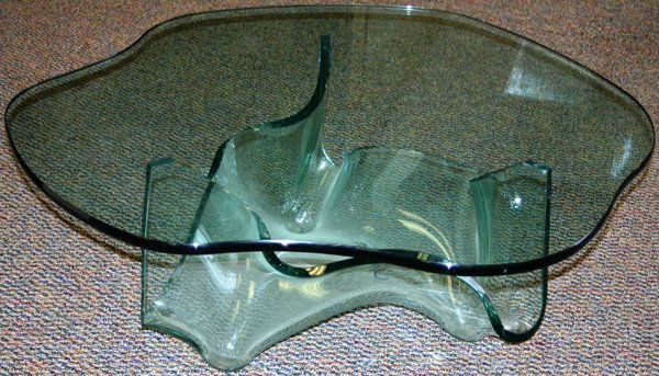 LAUREL FYFE, (AMER.) MODERN COCKTAIL TABLE: LAUREL FYFE, (AMER. 1956-2011), CONTEMPORARY, GLASS COCKTAIL TABLE, "AURORA", H 17", DIA 44":"Aurora" cocktail table having a contoured free form design top with a free form glass base;