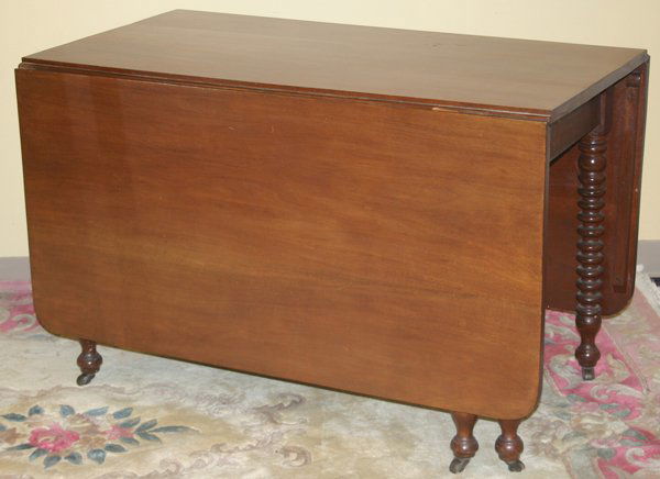 ANTIQUE MAHOGANY GATE LEG TABLE, C. 1900: ANTIQUE MAHOGANY GATE LEG TABLE, C. 1900, H 29", W 60", D 46":having two folding leaves of 23" each; when opened 60", when folded down table measures 26" D. spool form legs, on metal casters;