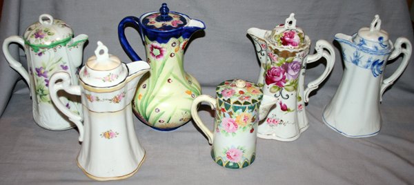 NIPPON PORCELAIN CHOCOLATE POTS, EARLY 20TH C.: NIPPON PORCELAIN CHOCOLATE POTS, EARLY 20TH CENTURY, SIX, H 6" - 10":includes various floral designs and colors, all with lids;