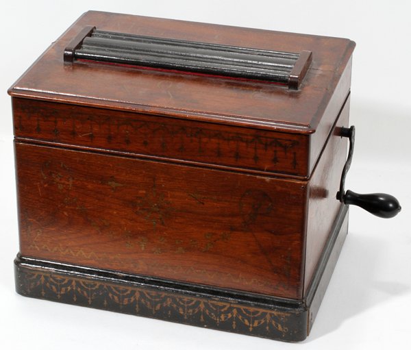 MECHANICAL ORGUINETTE CO. MUSICAL CASKET, H 9": MECHANICAL ORGUINETTE CO. OF NEW YORK MUSICAL CASKET, C. 1900, H 9", W 12", D 8 3/4":Plays 7 3/4" wide paper roll, with key.