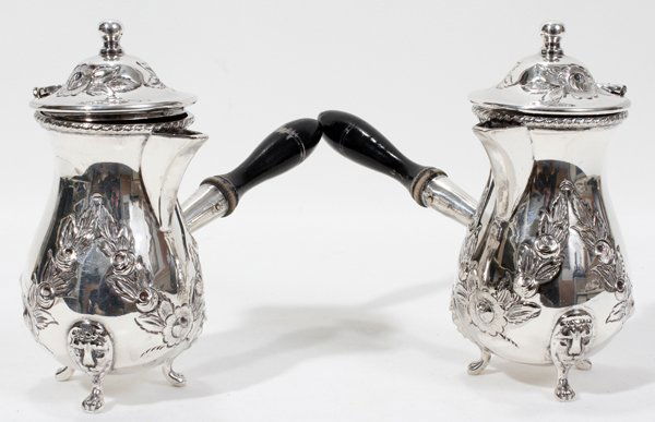 SILVER PLATED COFFEE POTS EBONY HANDLES, 19TH C: SILVER PLATED COFFEE POTS, EBONY HANDLES, 19TH CENTURY, PAIR, H 6", L 7" TO THE HANDLE:Each with a turned ebony handle, and floral and leaf motifs on the covers and bodies with lion masks at the knees