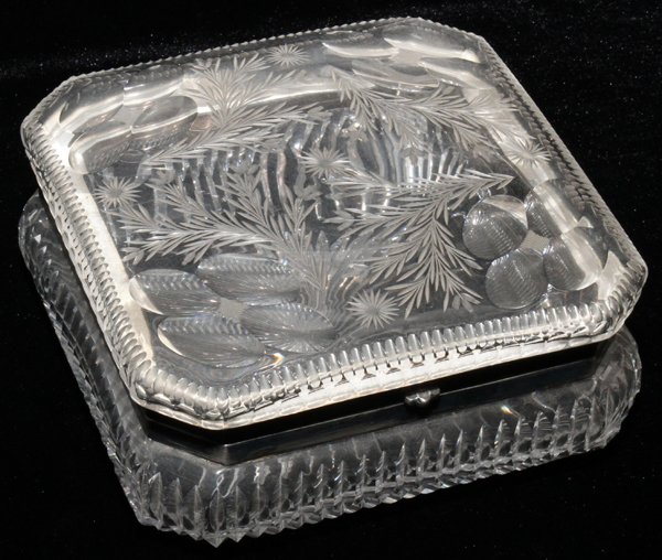 CUT GLASS DRESSER BOX, EARLY 20TH C., H 3": CUT GLASS DRESSER BOX, EARLY 20TH C., H 3", W 6 3/4":Square box with canted corners, etched floral motif at the cover, spear cuts about, hinged. No apparent marks.