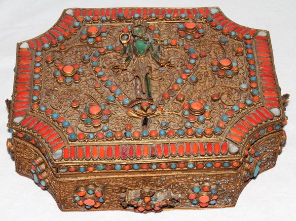NEPAL BRASS FILIGREE JEWEL BOX, H 3": NEPAL BRASS FILIGREE JEWEL BOX, H 3", W 7", L 9":Coral and tourquoise inset stones. Having figures on the side and top. Made in Nepal.