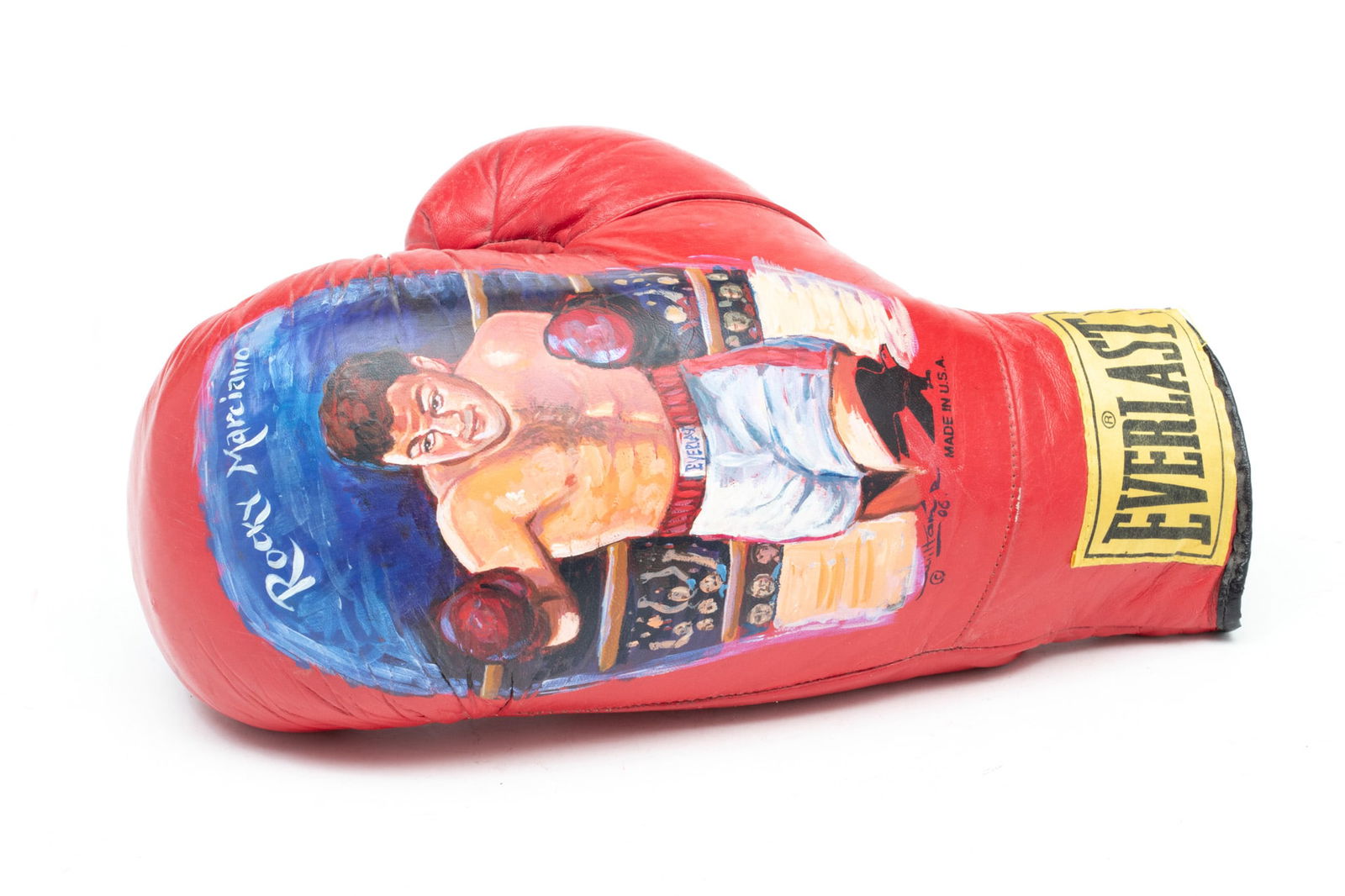 Hand Painted Portrait of Rocky Marciano Boxing Glove, Ca. 2006, L 12.5": Hand Painted Portrait of Rocky Marciano Boxing Glove, Ca. 2006, L 12.5" | 16oz Everlast boxing glove having a hand painted portrait of former heavyweight boxing champion Rocky Marciano (49-0).
