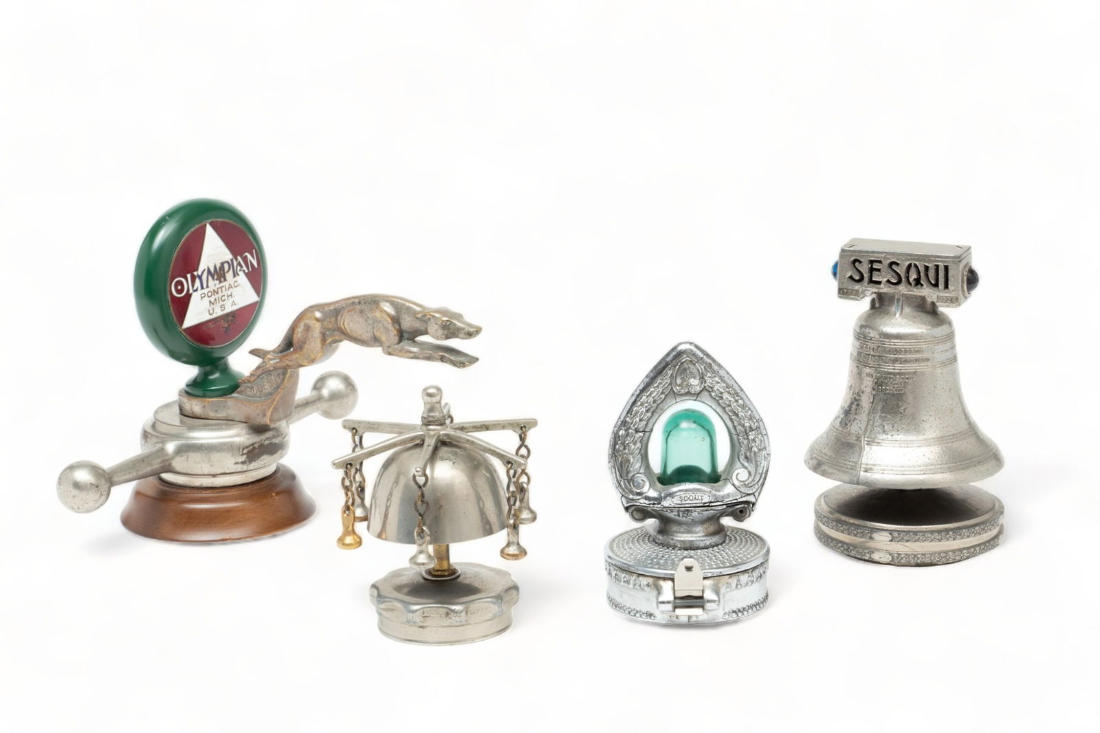American And French Motor Mascots, Ca. 1920s-30s, 4 pcs: American And French Motor Mascots, Ca. 1920s-30s, 4 pcs | Lot includes one Sesqui 1776-1926 liberty bell mascot. Die cast nickel plated. Unmarked at the top. Lights up and the bell rings from the dash
