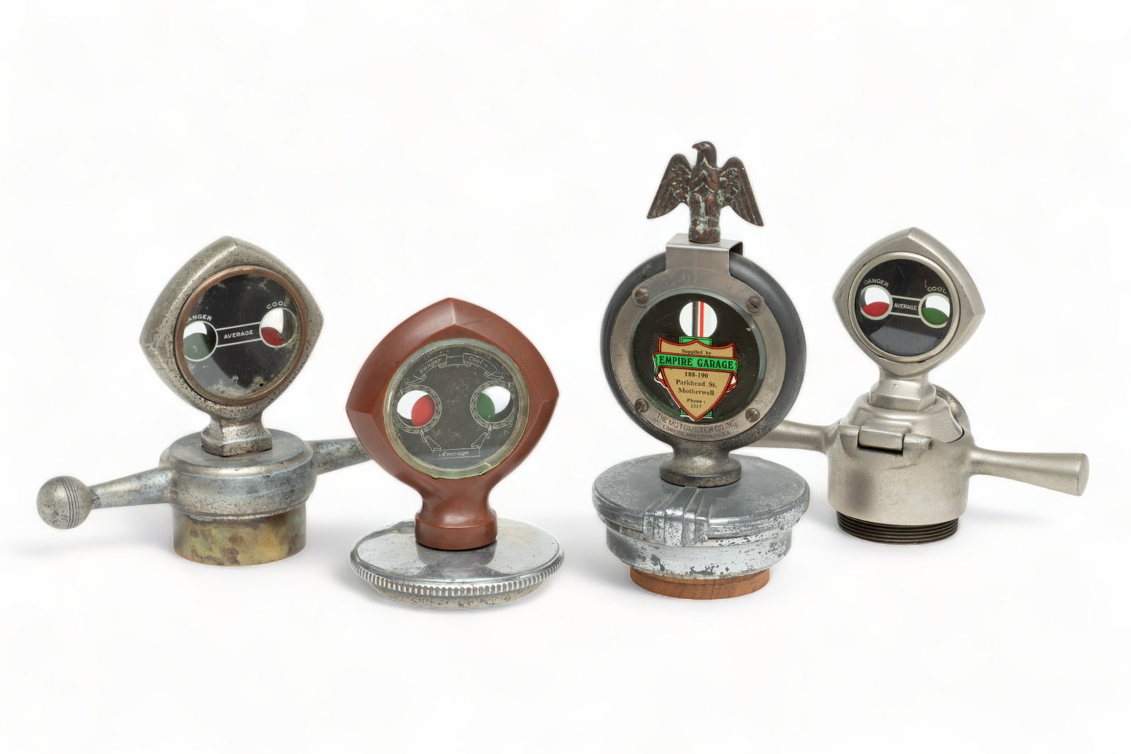 Collection of Four Motometers with Mountings, Ca. 1920s, 4 pcs: Collection of Four Motometers with Mountings, Ca. 1920s, 4 pcs | Lot includes one Moore motor semaphore manufactured by the Semaphoric Indicator Co., Chicago. Having a dog bone mounting. H 5.5", W 7",