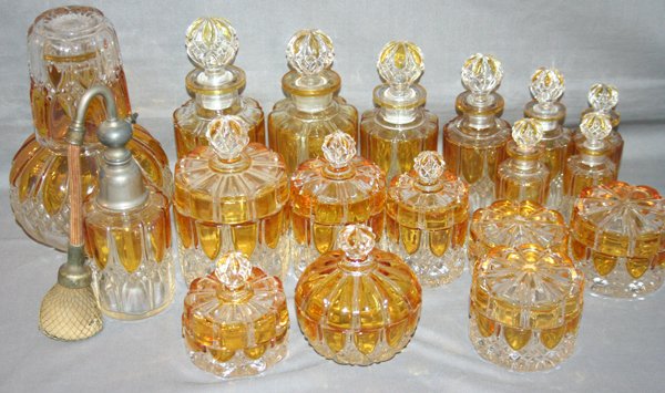 VAL ST. LAMBERT GLASS VANITY ITEMS, 18 PCS: VAL ST. LAMBERT GLASS VANITY ITEMS, 18 PCS, H 4" - 8":Pressed clear to amber glass. Includes 3 powder jars, 5 covered dresser jars, 8 perfume bottles, 1 carafe with cover, 1 glass plus 1 perfume with 