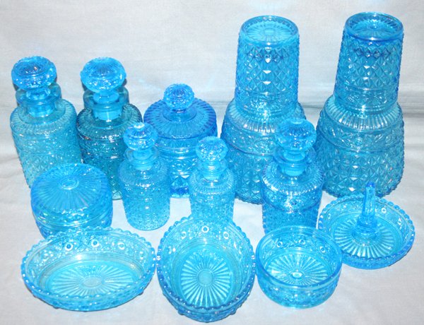 VAL ST. LAMBERT PRESSED GLASS DRESSER ITEMS: VAL ST. LAMBERT PRESSED BLUE GLASS DRESSER ITEMS, 13 PCS, H 2" - 8":Including 2 carafes with covers/glasses; 5 perfume bottles; 2 powder jars ( 1 missing cover), 1 covered jar with finial, 1 ring dish